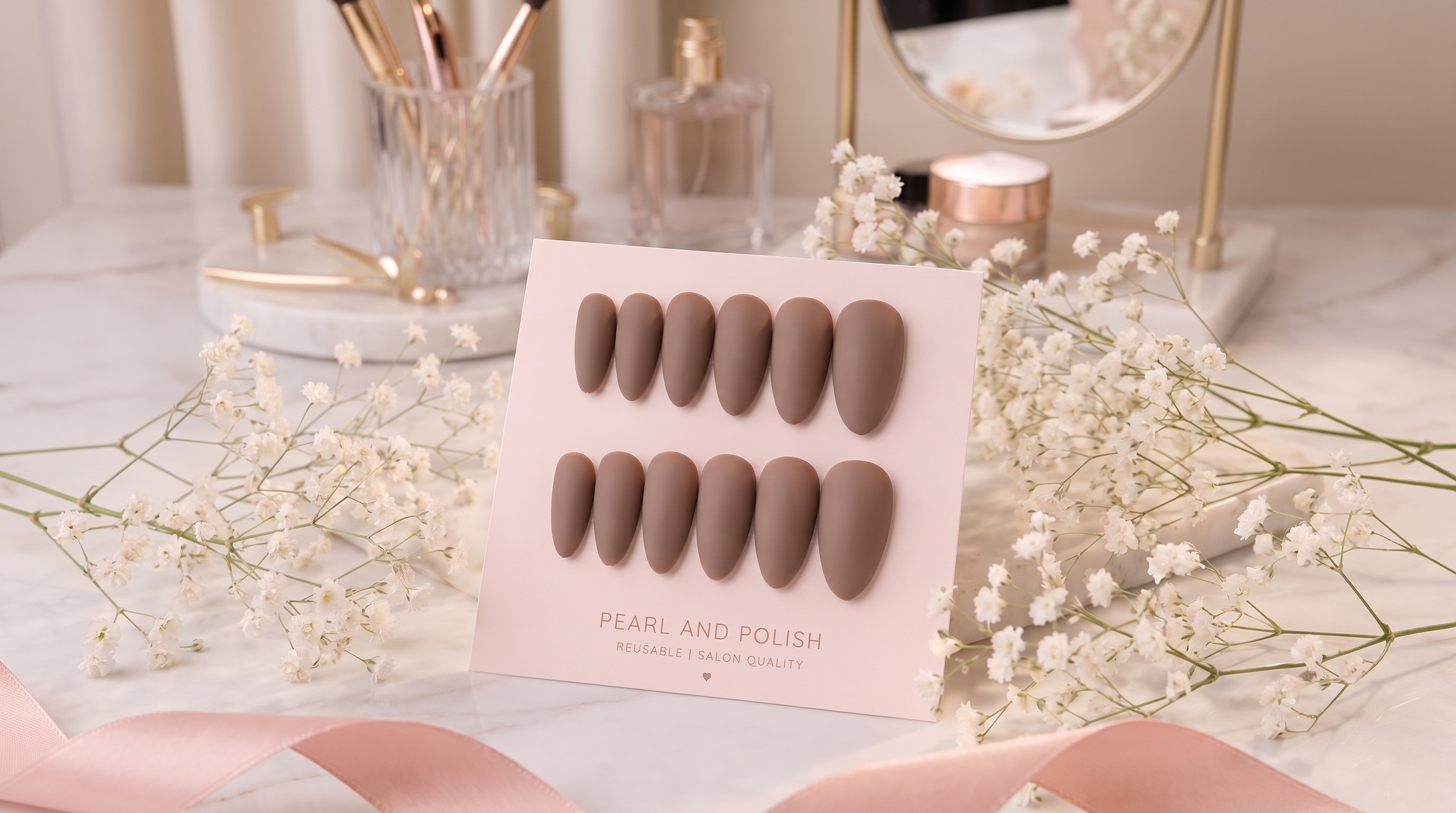 Cocoa Suede: brown matte almond press-on nails, displayed on a pink Pearl & Polish card